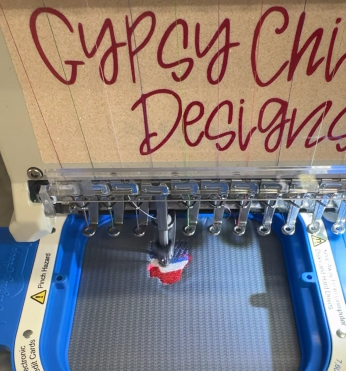 Embroidery machine stitching a custom design in-house at Gypsy Chicken Designs.